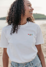 Lady wearing a plain embroidered t-shirt, and its set on the beach.