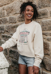 A lady wearing a printed cafŽ style printed sweatshirt, set by the sea.